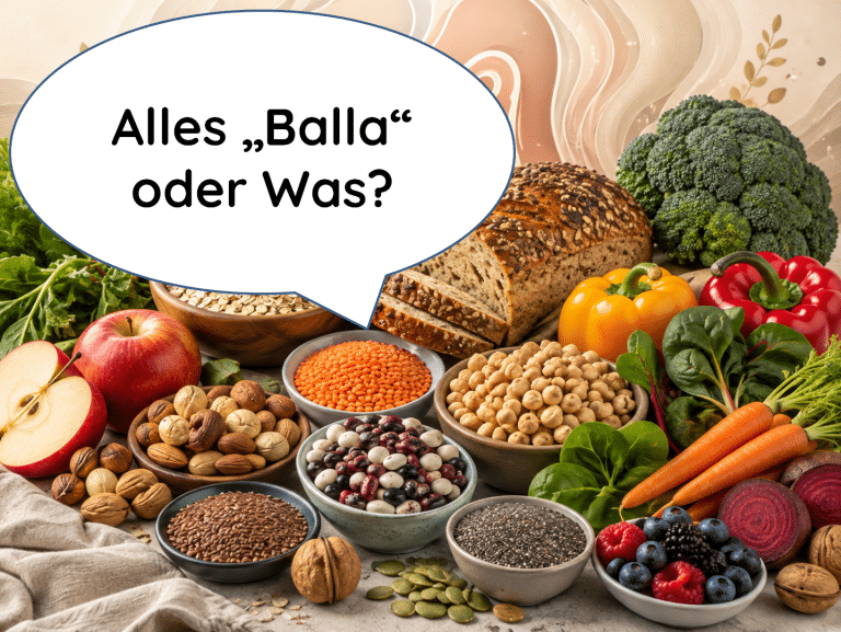 Titelbild zum Ballaststoff-Ratgeber: Eine bunte Vielfalt an ballaststoffreichen Lebensmitteln wie Vollkornbrot, Hülsenfrüchten, Nüssen und Gemüse, darüber eine Sprechblase mit dem humorvollen Text 'Alles „Balla“ oder Was?'